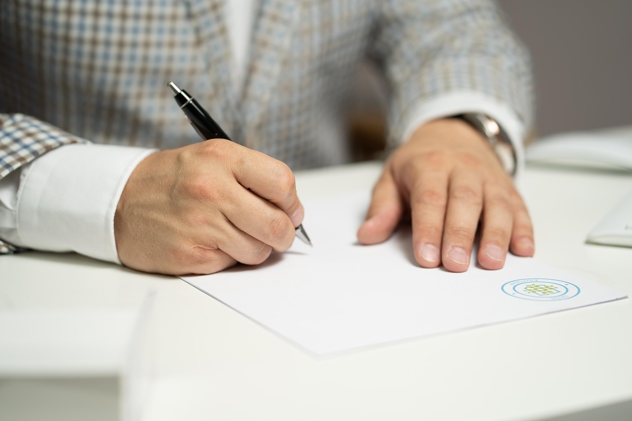 Close up of hands shaking over signed investment documents on a table