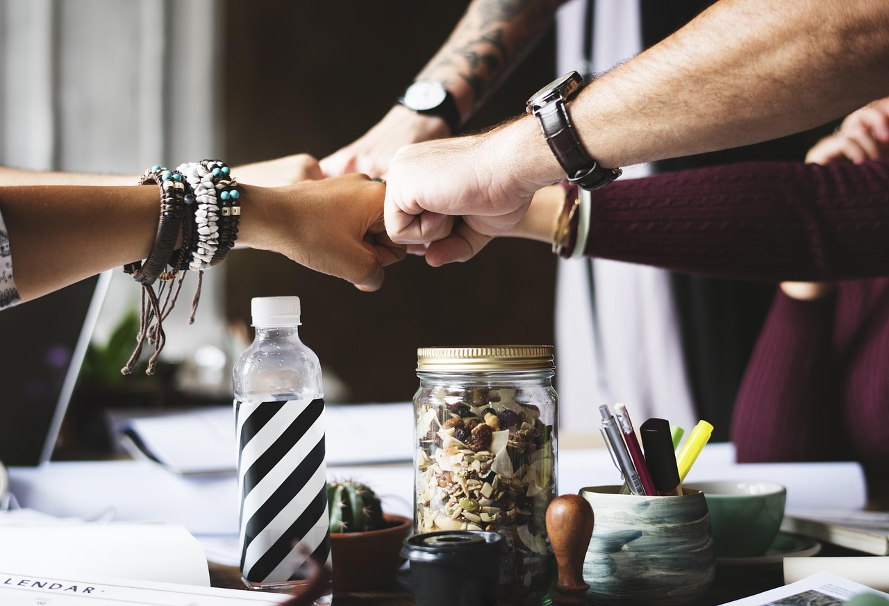 Small group of entrepreneurs in a calm meeting space having a supportive discussion
